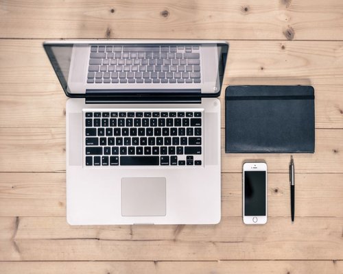 Phone notebook and water on a work desk